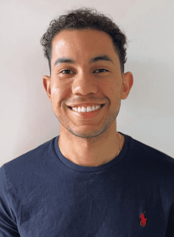 The image portrays physiotherapist Alexander Roberts, who has short curly hair.